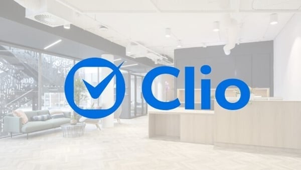 Image of the blue Clio logo against an office background
