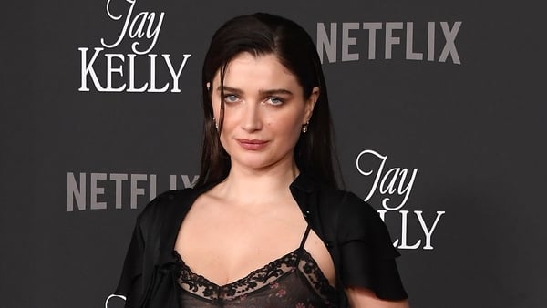 Eve Hewson wears a black lace bra top and sparkly black skirt on the red carpet at the premiere of Jay Kelly