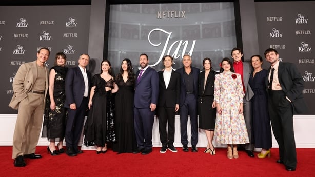 LOS ANGELES, CALIFORNIA - NOVEMBER 11: (L-R) Patrick Wilson, Emily Mortimer, David Heyman, Eve Hewson, Sadie Sandler, Adam Sandler, Noah Baumbach, George Clooney, Riley Keough, Grace Edwards, Louis Partridge, Nina Gold and Charlie Rowe attend Netflix's "Jay Kelly" Los Angeles premiere at The Egyptia