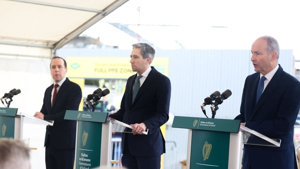 From left to right are James Browne, Simon Harris and Micheal Martin standing behind lecterns