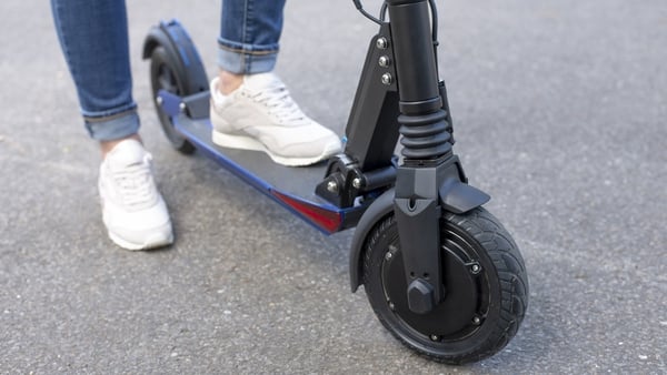 A partial view of a woman with E-Scooter