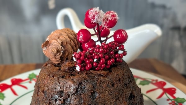 A Christmas pudding topped with red berries