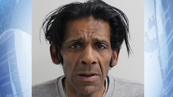 police shot of Peter Augustine's face on a blue background