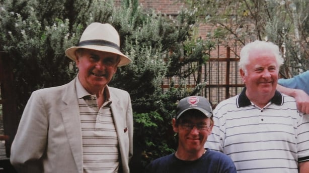 Three men pose for a photo