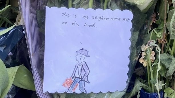 A handdrawn image of a man in a suit and hat on front of bouquet of flowers