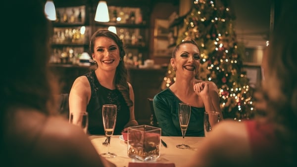 Group of women, having fun indoors, holding glasses with champagne, having a toast.
