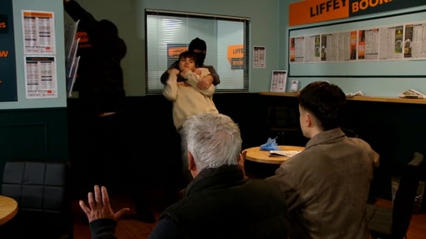 Tommy and Zak get on their knees as the robbery takes place