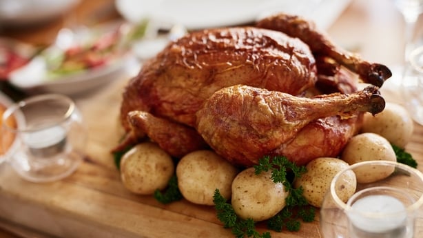 Thanksgiving, food and a roast chicken on a table in the dining room from above for celebration. Celebration, meat and turkey with a meal or feast in a home for a social event or american tradition