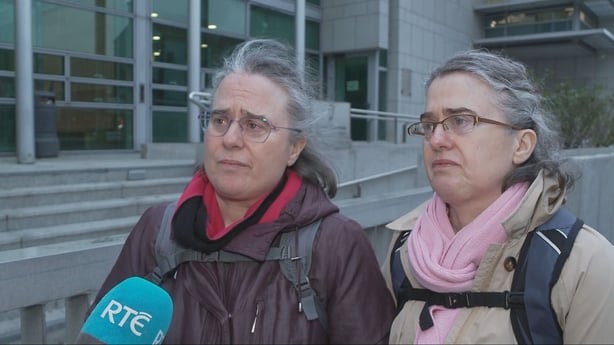 Twin sisters Mary and Regina Cooney speak to reporter Laura Hogan outside court