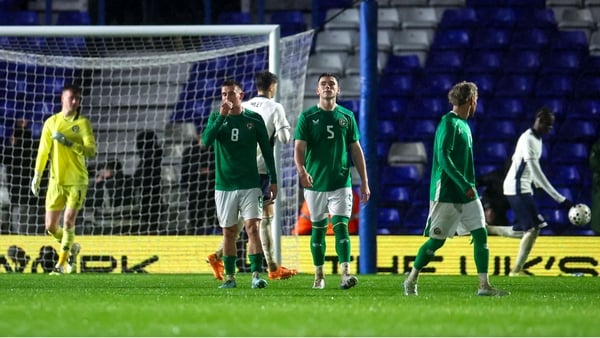 Republic of Ireland players Adam Murphy, 8, and Sean Grehan, 5, after Divin Mubama of England, right, scored his side's first goal, from a penalty, past Republic of Ireland goalkeeper Noah Jauny during the UEFA European U21 Championship qualifier group D