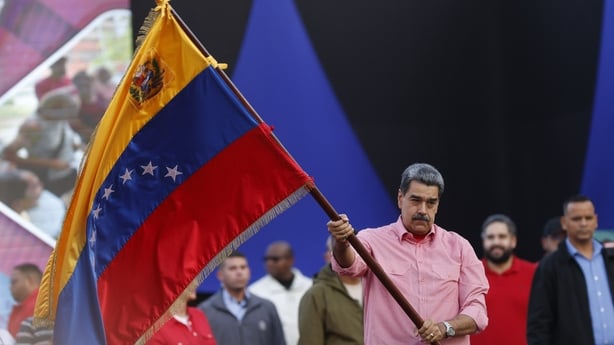 Venezuela's President Nicolas Maduro waves a Venezuelan flag during a demonstration for the swearing-in of Bolivarian committees in Caracas