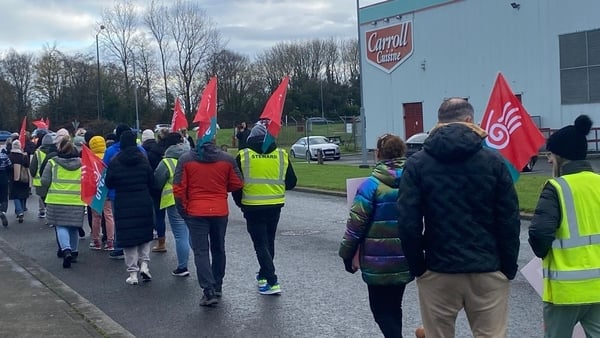 People hold a rally outside Carrolls cuisine in Offaly