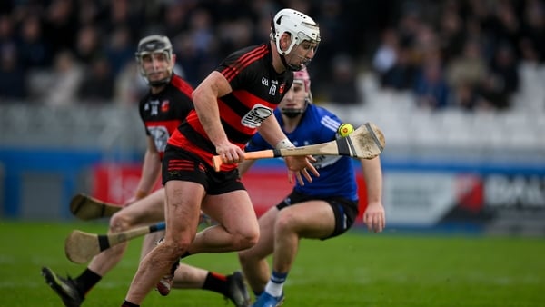 16 November 2025; Dessie Hutchinson of Ballygunner gets away from Donal English of Sarsfields on the way to scoring his and his side's second goal during the AIB Munster GAA Hurling Senior Club Championship semi-final match between Ballygunner and Sarsfie