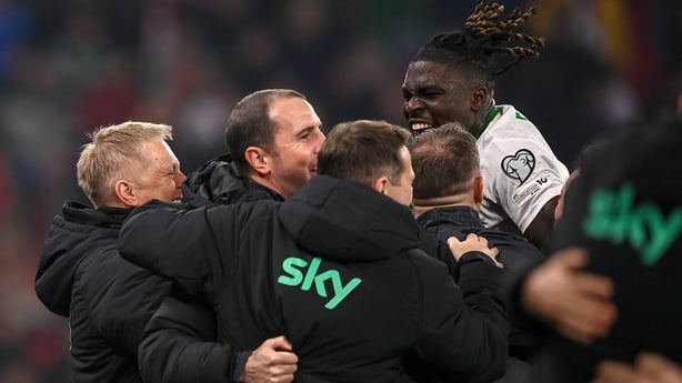 Festy Ebosele of Republic of Ireland celebrates with Republic of Ireland head coach Heimir Hallgrimsson and Republic of Ireland assistant head coach John O'Shea after the FIFA World Cup 2026 Group F Qualifier match between Hungary and Republic of Ireland at Puskás Aréna in Budapest, Hungary.