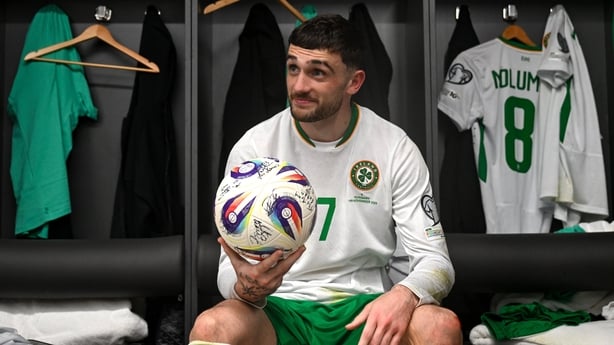 Troy Parrott of Republic of Ireland celebrates with the match ball in the dressing room after scoring a hat-trick in the FIFA World Cup 2026 Group F Qualifier match between Hungary and Republic of Ireland at Puskás Aréna in Budapest, Hungary.