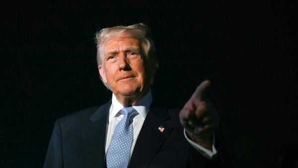 Donald Trump stands with his finger pointed