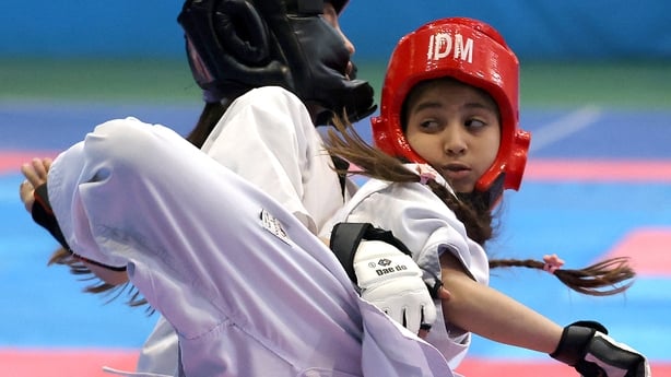 Two girls compete in a women's karate competition