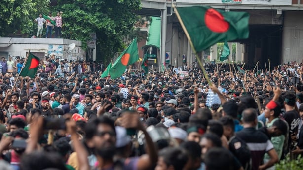 crowds of people with some waving flags in bangladesh in 2024