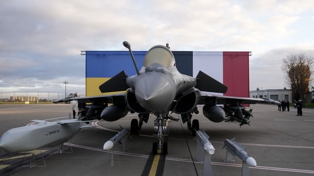 This photograph shows a Rafale jet fighter and a Storm Shadow (Scalp) missile with Ukraine's and France's national flags in the background
