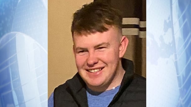 A photograph on a blue background of dylan commins