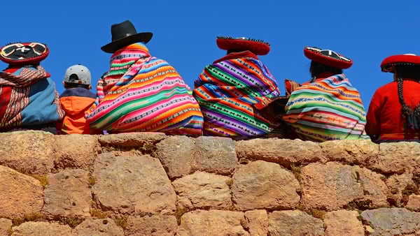 Photo of the back of Quechua ladies sitting