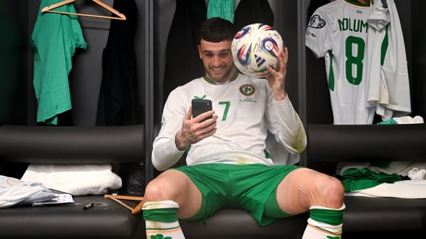 16 November 2025; Troy Parrott of Republic of Ireland celebrates with the match ball in the dressing room after scoring a hat-trick in the FIFA World Cup 2026 Group F Qualifier match between Hungary and Republic of Ireland at Puskás Aréna in Budapest, Hungary. Photo by Stephen McCarthy/Sportsfile