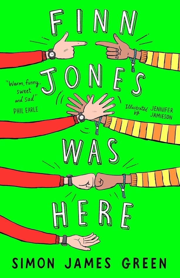 A green book cover with hand gestures and the text Finn Jones Was Here