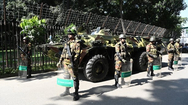 Bangladesh's army personnel stand guard next to a military vehicle at the International Criminal Tribunal premises in Dhaka