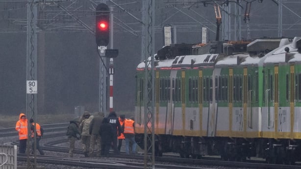 Investigators examine the railways damaged in an explosion on the rail line in Mika