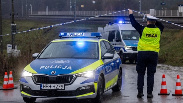 Police cars and tape seen close to the railways that were damaged in an explosion on the rail line in Mika