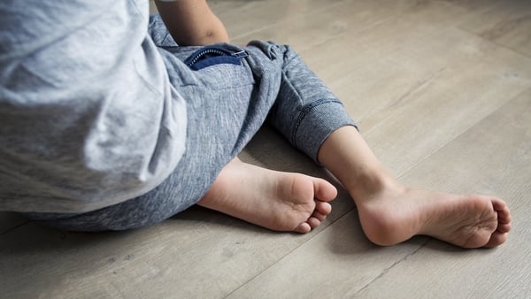 generic image of a small boy sitting on the floor