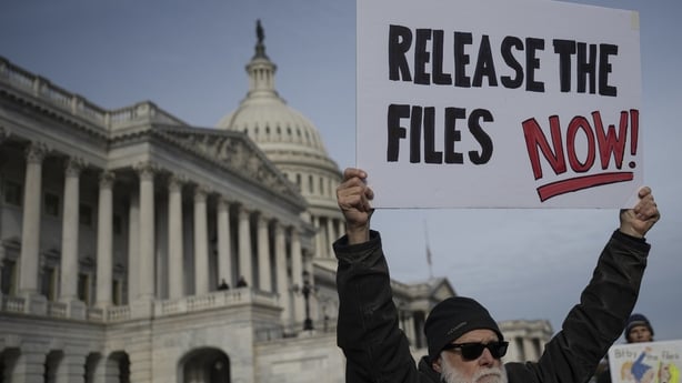 A man holds a sign at a demonstration calling the release of the Epstein files