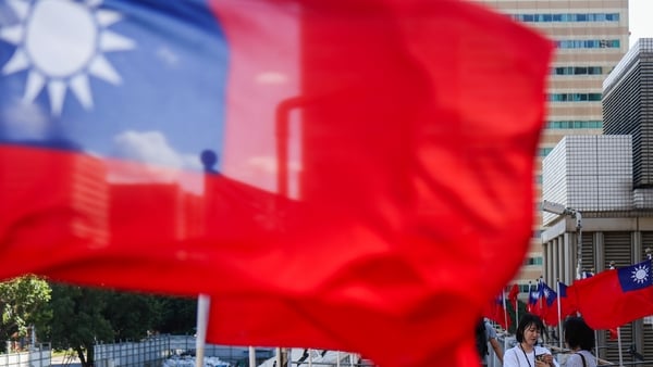 People take photos with national flagsin Taipei, Taiwan