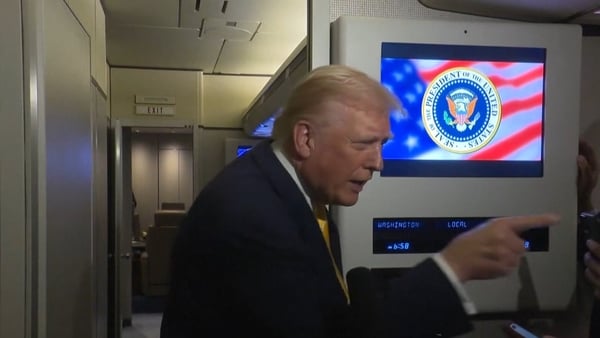 US President pointing at reporter Mary Bruce aboard Air Force 1.