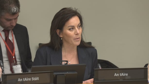 A screengrab showing jennifer carroll macneill addressing a committee hearing
