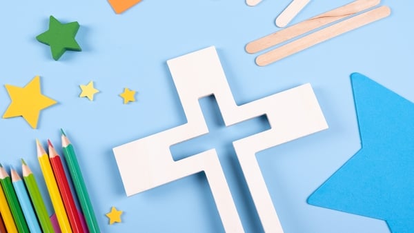 image of a cross with coloured paper and pens in a primary school