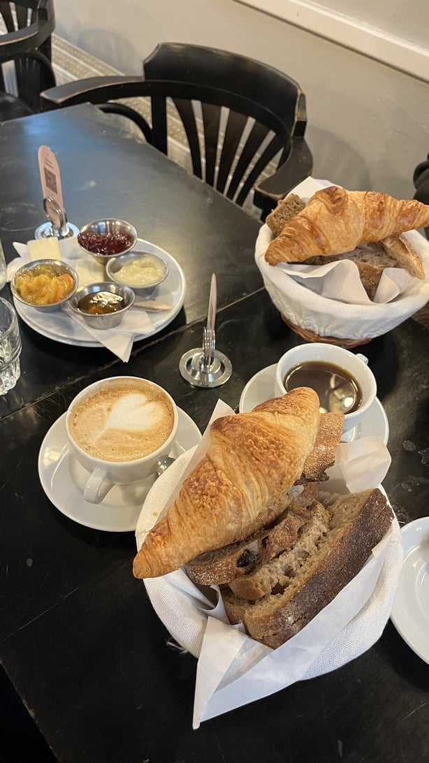 Plates of croissants, breads and spreads and jams in a cafe