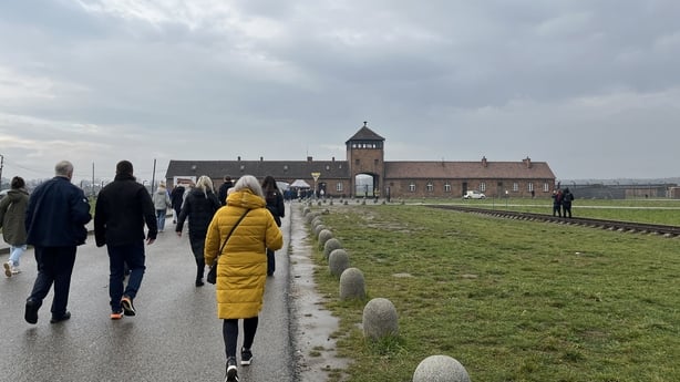 A photo of visitors at the train station in Birkenau, Krakow