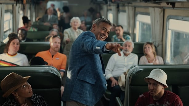 Jay Kelly meets his adoring public on a train Photo: Peter Mountain/Netflix