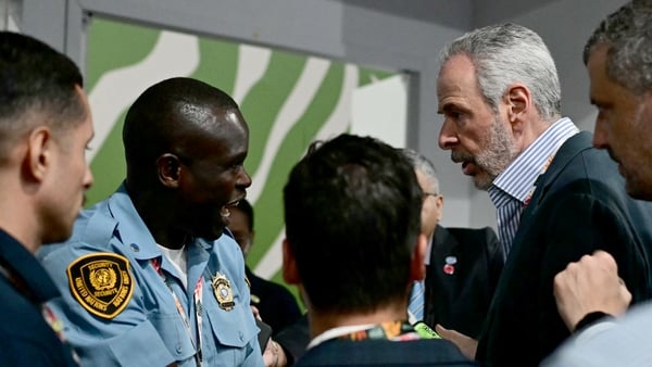 COP30 President Andre Correa do Lago (right) argues with a UN police officer who denied him access to a room during the COP30 UN Climate Change Conference in Belem