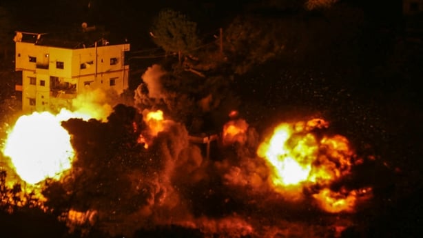 Flames and smoke erupt from the site of an Israeli airstrike that targeted a house in southern Lebanon