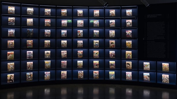 This photograph shows a bookshelf of manga magazines, seen during a press visit to the exhibition Manga, tout un art!" at the Guimet Museum in Paris, on 18 November, 2025