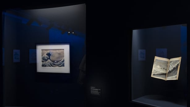 This photograph shows Japanese artist Katsushika Hokusai's masterpiece (L) The Great Wave off Kanagawa, seen during a press visit to the exhibition Manga, tout un art! at the Guimet Museum in Paris, on 18 November, 2025