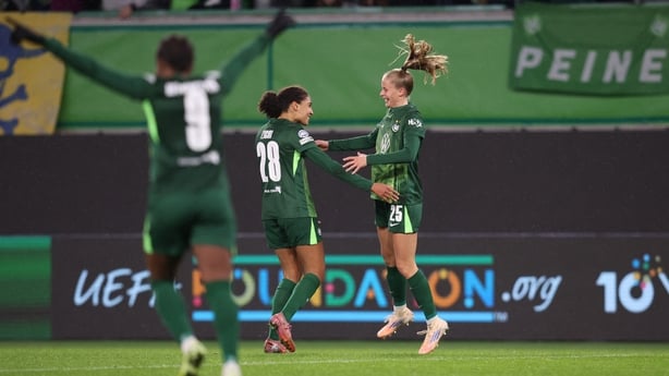 VfL Wolfsburg's Vivien Endemann, right, celebrates with team-mate Cora Zicai after scoring the team's fifth goal