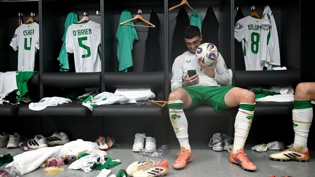 16 November 2025; Troy Parrott of Republic of Ireland celebrates with the match ball in the dressing room after scoring a hat-trick in the FIFA World Cup 2026 Group F Qualifier match between Hungary and Republic of Ireland at Puskás Aréna in Budapest, Hungary. Photo by Stephen McCarthy/Sportsfile