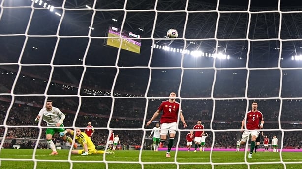 16 November 2025; Troy Parrott of Republic of Ireland scores his side's second goal past Hungary goalkeeper Dénes Dibusz during the FIFA World Cup 2026 Group F Qualifier match between Hungary and Republic of Ireland at Puskás Aréna in Budapest, Hungary. Photo by Stephen McCarthy/Sportsfile