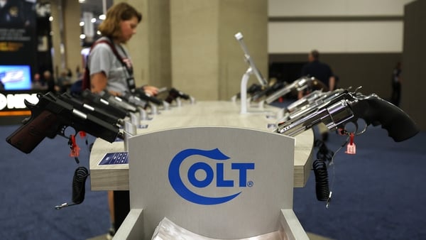 Colt logo displayed at a Colt booth displaying different guns at a US gunshow