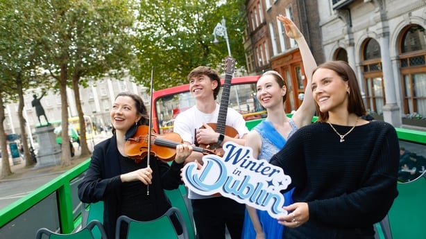 Irish perfromers on an open top bus