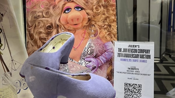 The Miss Piggy-signed Cover Girl fantasy calendar 1981 and a pair of her production-worn shoes for the Couldn't We Ride bicycle scene from The Great Muppet Caper are displayed during a preview of the Jim Henson Company anniversary auction at Julien's Auct