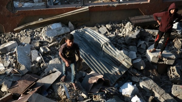 Palestinians inspect the debris of a damaged building in Zeitoun, Gaza City